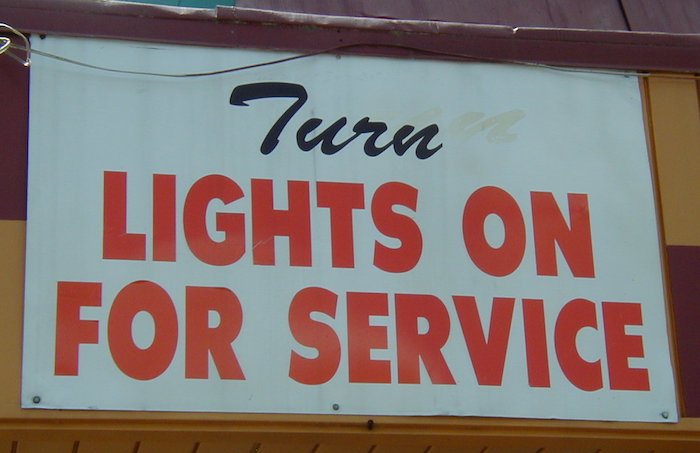 Sign: Turn lights on for service