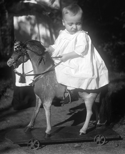 Toddler riding a toy horse
