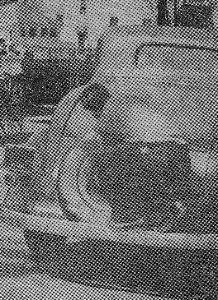 Boy riding car bumper, 1938